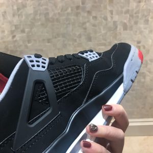 A pair of sport shoes marked Nike Air Jordan 4 Retro size 9.5